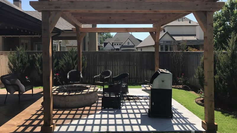 Photo of an outdoor living space with a firepit on the patio.